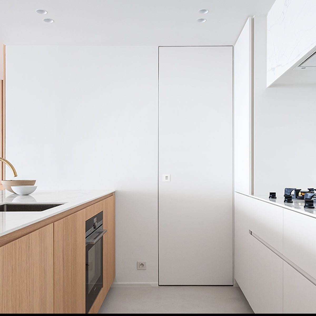 A white invisible frame door, also called dib door or hidden door.